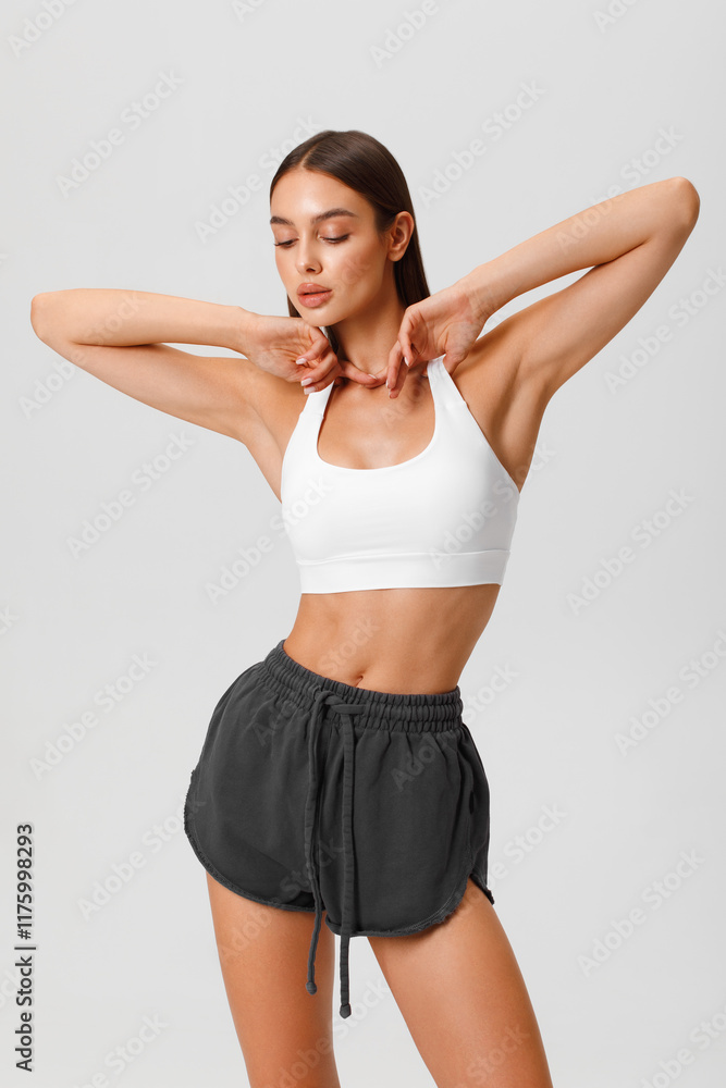 Fitness woman. Athletic girl on the gray background Fitness woman. Athletic girl on the gray background