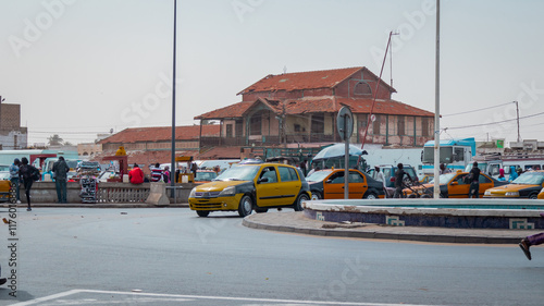 Obraz na płótnie Former train station building in Sant Louis, collonial city on the north of Senegal. Here used to be a railroad track to dakar, now a busy market. w salonie