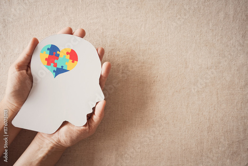 Foto Hands holding jigsaw puzzle heart shape in brain, Autism awareness, handicap dis