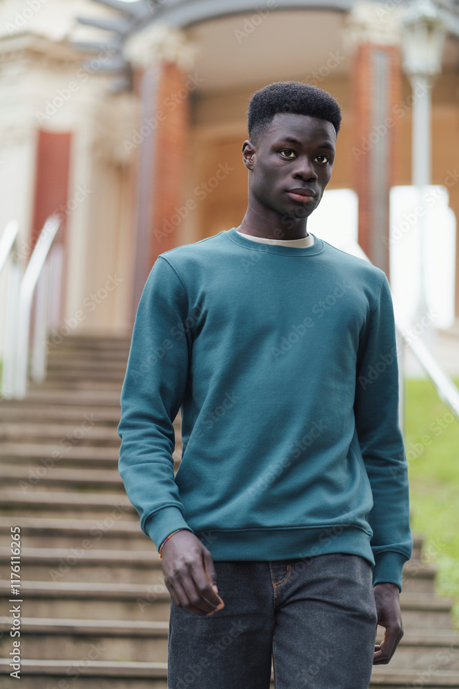 Stylish young man walking down stairs in urban environment Stylish young man walking down stairs in urban environment