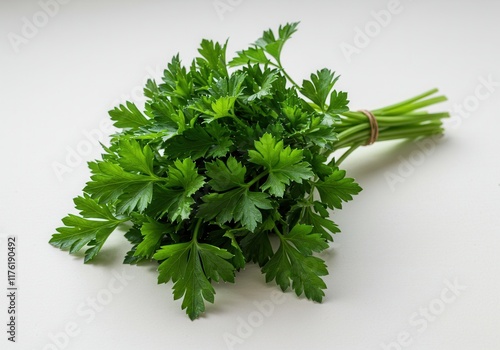 Fresh bunch of parsley on white background showcasing vibrant green leaves for culinary use photo