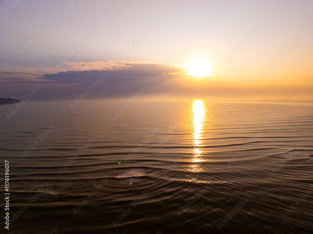 Naklejka premium Aerial view sunset sky,Nature beautiful light sunset or sunrise over sea,Colorful scenery sunset sky,Amazing clouds and waves texture, sunrise sky background