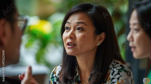 Wallpaper Mural Diverse Group of Colleagues Engaged in Discussion in a Modern Office Setting with Lush Greenery and Intimate Atmosphere Torontodigital.ca