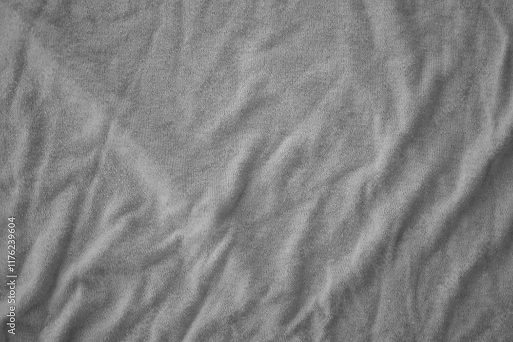 Naklejka premium Texture of Dark grey crumpled textile cloth part with small folds