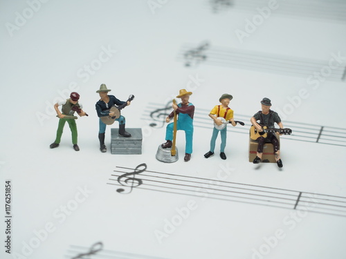 Mini toy of action figure at outdoor with blurred background. Toy photography concept design. Minifigure of musician character with musical notes on the paper. photo