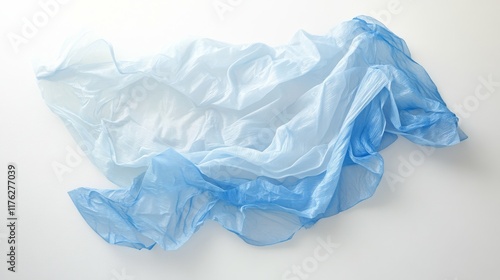 21.A wrinkled light blue plastic bag lying flat on a white background, with soft lighting emphasizing the creases and transparency, capturing the simplicity and ubiquity of single-use plastics. photo