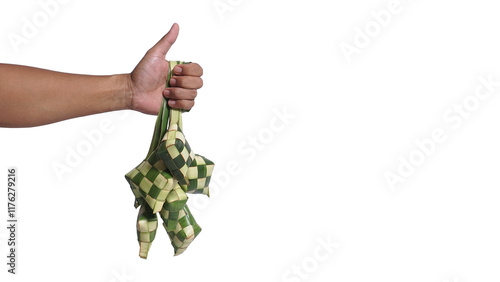 Hand holding ketupat or rice dumpling with thumbs up on white background with copy space. Traditional culture welcoming ramadan season or eid al fitr photo