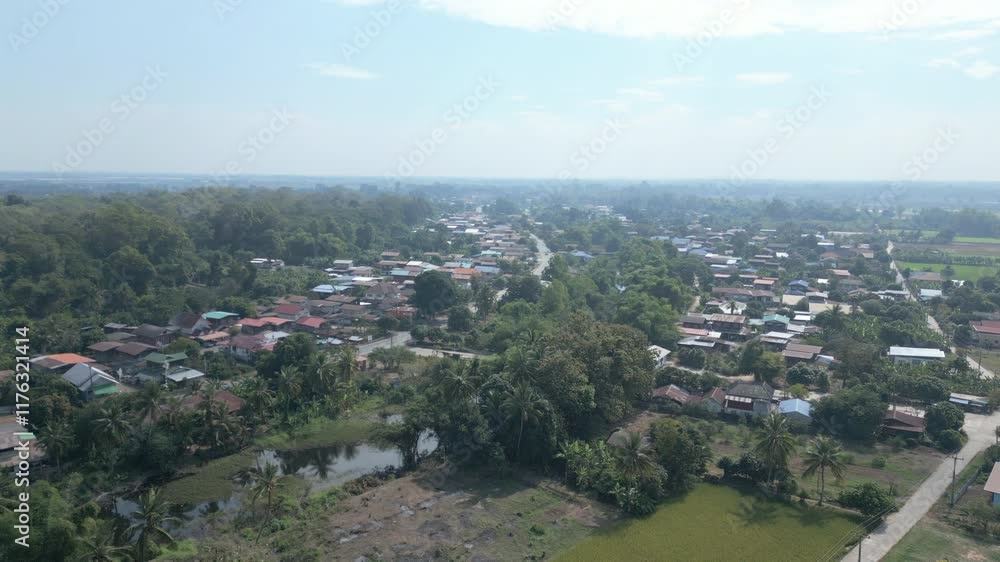 Aerial View of a Peaceful Rural Village Surrounded by Greenery and Tropical Landscape Aerial View of a Peaceful Rural Village Surrounded by Greenery and Tropical Landscape