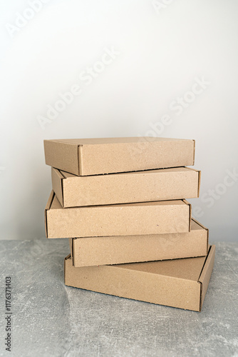 Stack of flat-packed self-assembly cardboard boxes for packaging and gift wrapping.