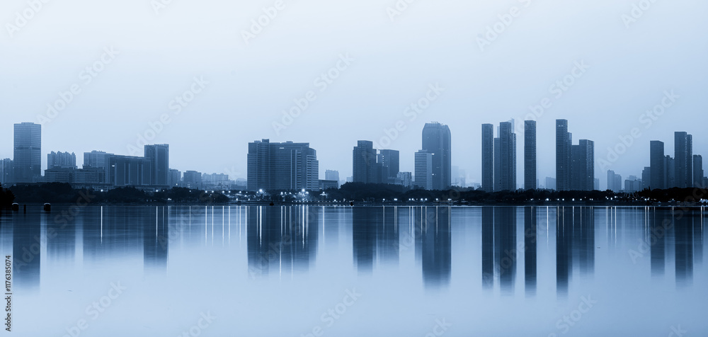 Naklejka premium Serene Urban Landscape at Dusk with Reflective Waters