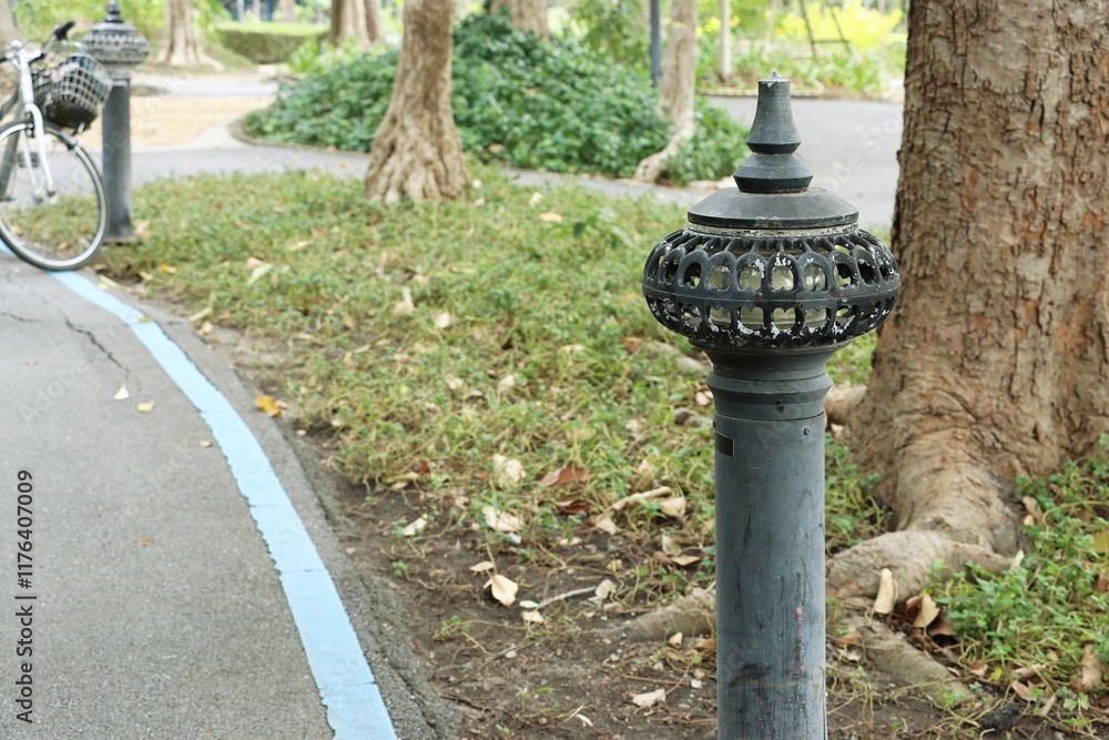 Old floor lamp along the walkway in public park Old floor lamp along the walkway in public park