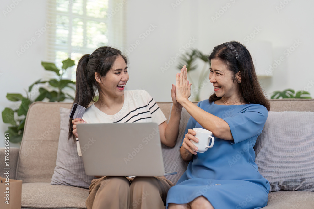 Mother and Child Enjoying Online Shopping Together with Credit Card and Laptop in Cozy Home Setting Mother and Child Enjoying Online Shopping Together with Credit Card and Laptop in Cozy Home Setting