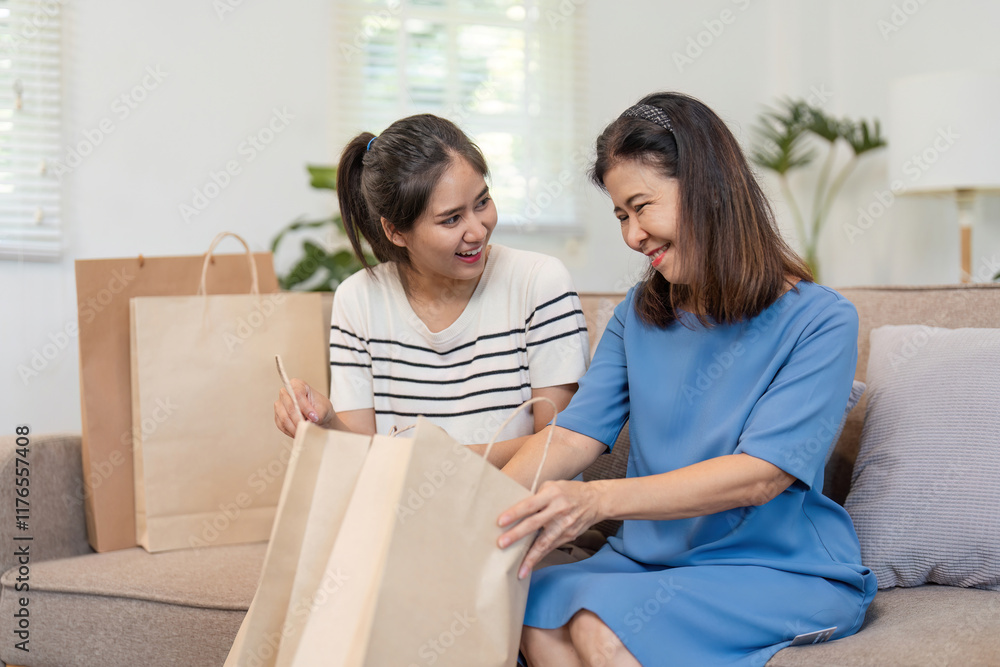 Mother and Child Enjoy Online Shopping Together Using a Credit Card in a Cozy Home Environment Mother and Child Enjoy Online Shopping Together Using a Credit Card in a Cozy Home Environment