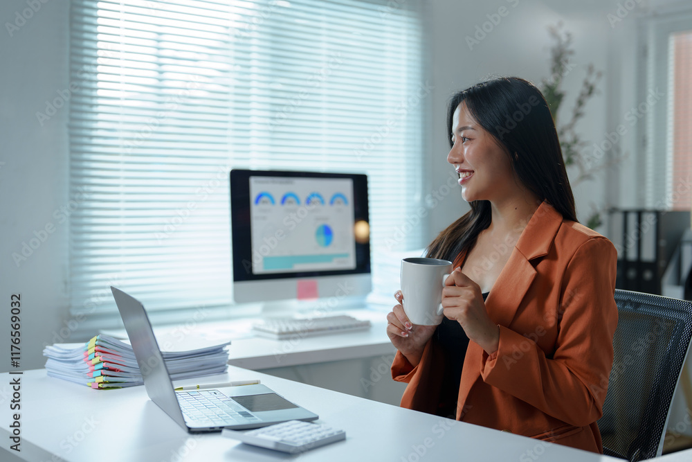 Young professional enjoying a coffee break while reviewing data and reports on her laptop, embodying a vibrant and modern office atmosphere filled with productivity and focus Young professional enjoying a coffee break while reviewing data and reports on her laptop, embodying a vibrant and modern office atmosphere filled with productivity and focus