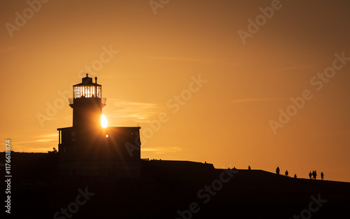 Vivid January sunset behind Belle Tout Lighthouse Beachy Head on the east Sussex coast south east England UK photo