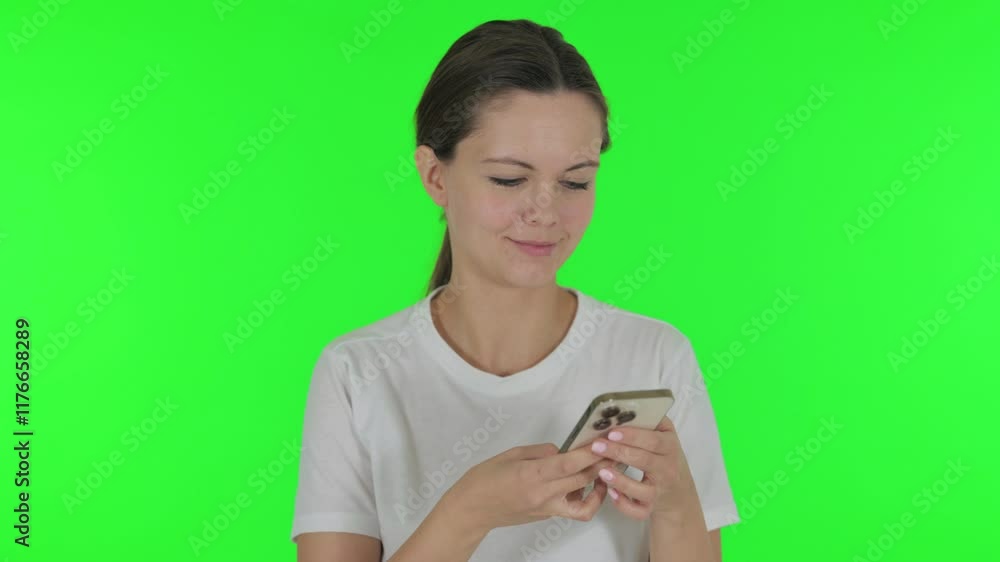 Young Woman using Phone on Green Background Young Woman using Phone on Green Background