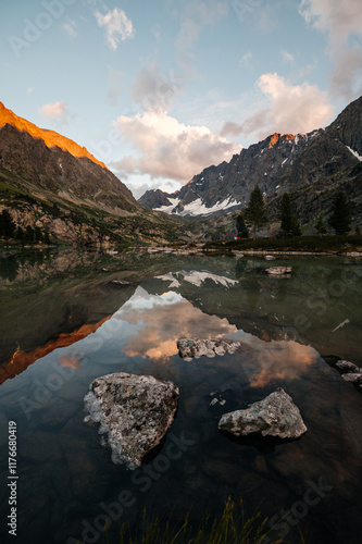Kuyguk mountain lake in Altai in the light of a beautiful sunset sky