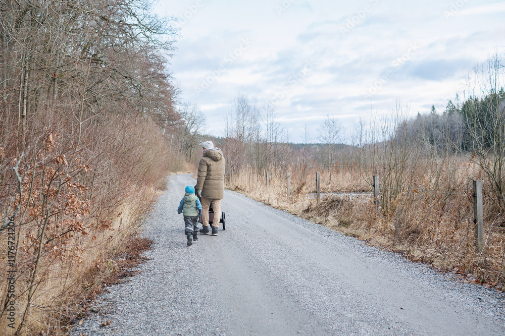 Parent and child walking on a quiet countryside r Parent and child walking on a quiet countryside r