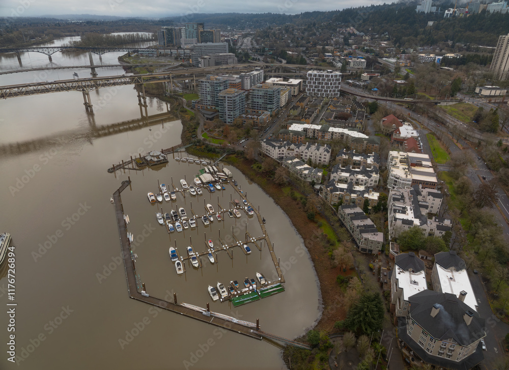 A city with a river running through it and a marina with many boats
