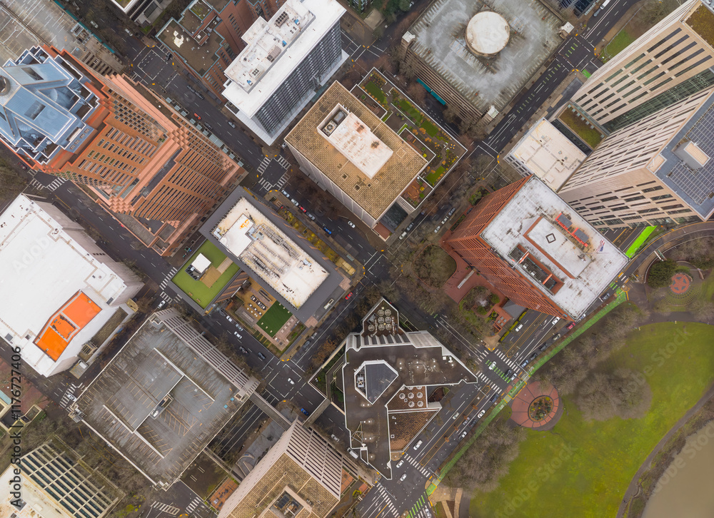 A city view from above with tall buildings and a park