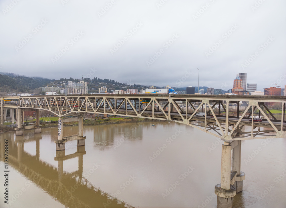 A bridge spans a river with a train passing underneath