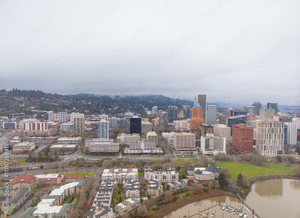 A city view with a lot of buildings and a lake in the background