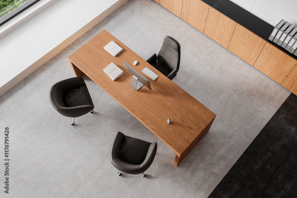Naklejka premium Minimalist modern office setup with wooden desk and dark chairs on concrete floor. 3D Rendering