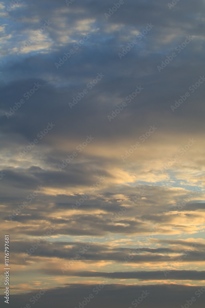 The sky is light blue with white and gray clouds. The clouds seem to spread across the sky. The sunlight shines down on the clouds, making them look soft. The sky looks peaceful. The sky is light blue with white and gray clouds. The clouds seem to spread across the sky. The sunlight shines down on the clouds, making them look soft. The sky looks peaceful.