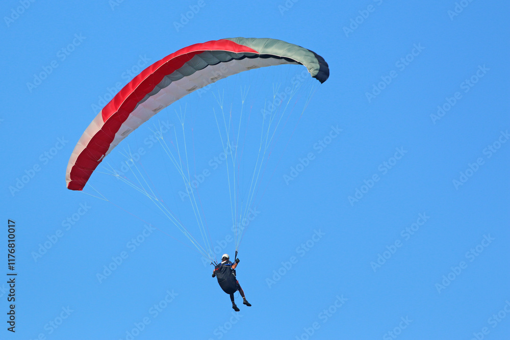 Paraglider flying in a blue sky Paraglider flying in a blue sky