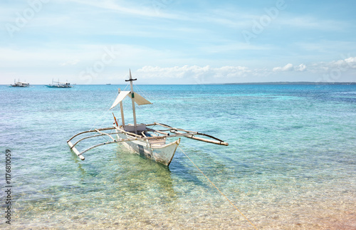 Bangka boat on the shore of Malapascua Island, Philippines. photo