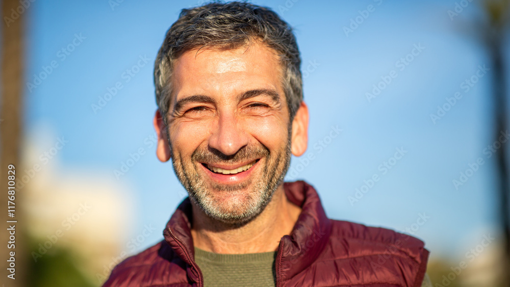 Fototapeta premium Close-up portrait of smiling middle-aged man outdoors