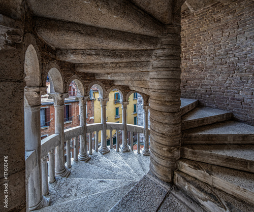 The elegant spiral staircase of Palazzo Contarini del Bovolo leads to colorful buildings in Venice