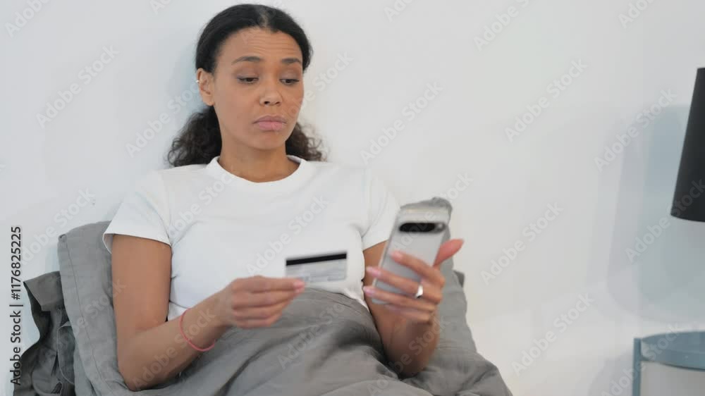 African Woman Enjoying Online Shopping in Bed African Woman Enjoying Online Shopping in Bed