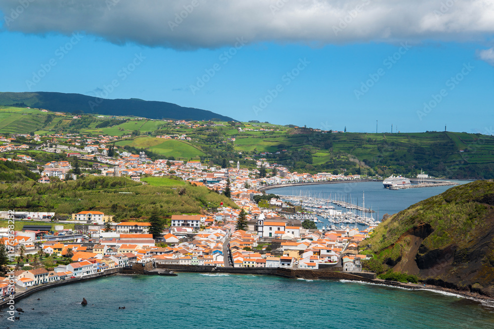 The City of Horta and Horta Bay of the Azores, Portugal. Aerial view of Portuguese town Horta on an the Atlantic ocean coast, on a sunny day, Faial island. The City of Horta and Horta Bay of the Azores, Portugal. Aerial view of Portuguese town Horta on an the Atlantic ocean coast, on a sunny day, Faial island.