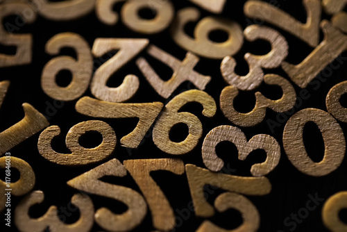 Close-Up of Wooden Numbers in Random Pattern on Dark Background photo