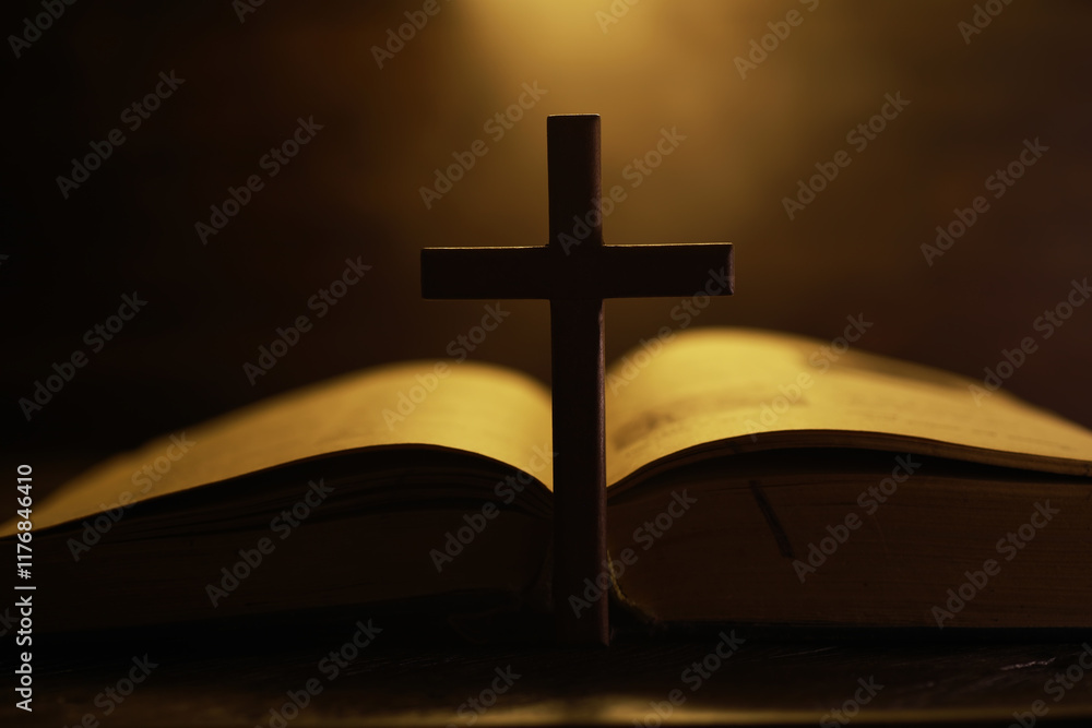 Cross Silhouette Over Open Bible with Warm Light - Spirituality and Faith Concept Cross Silhouette Over Open Bible with Warm Light - Spirituality and Faith Concept