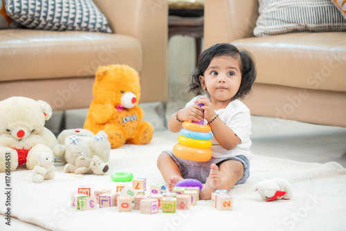 Indian Baby Playing With Rainbow Stacking Rings