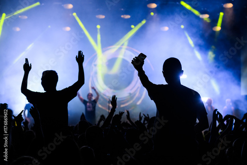 Energetic crowd at a live concert with light beams photo