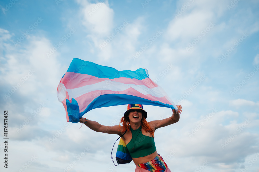 Young activist waving transgender pride flag in the wind Young activist waving transgender pride flag in the wind