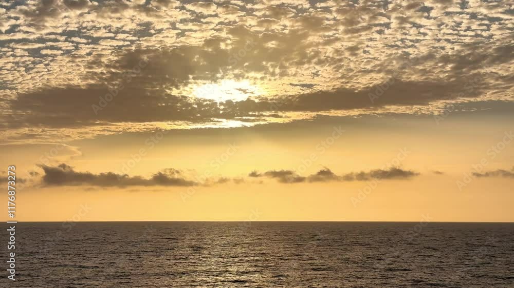 Ocean sunset view from a transport vessel, featuring calm blue waters, gentle waves, and a vibrant orange and yellow sky merging into the horizon, highlighting the beauty of nature and twilight Ocean sunset view from a transport vessel, featuring calm blue waters, gentle waves, and a vibrant orange and yellow sky merging into the horizon, highlighting the beauty of nature and twilight