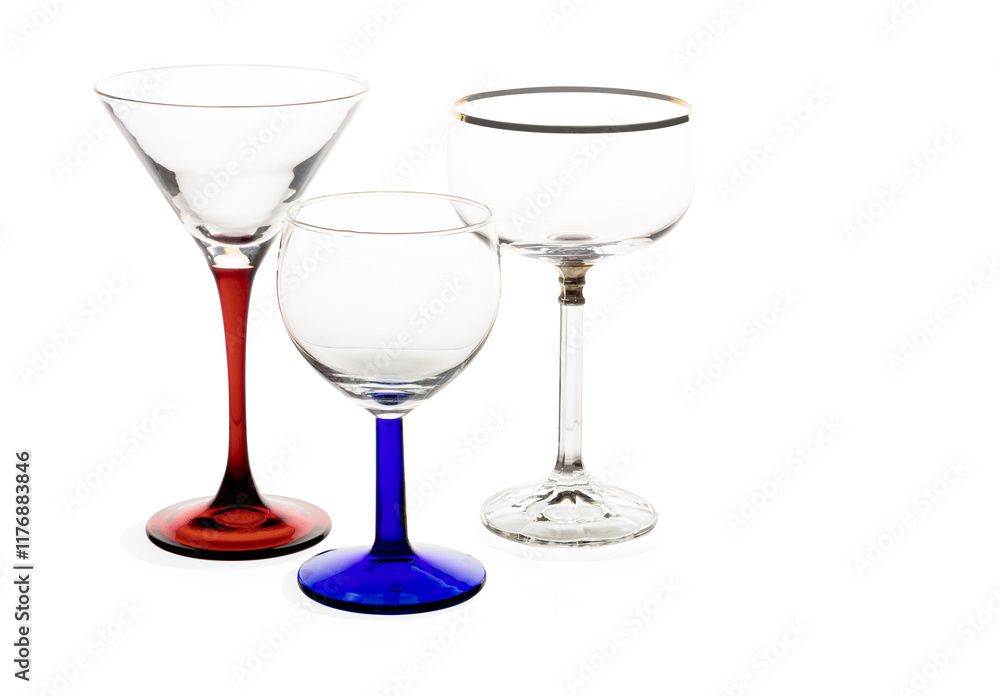 Isolated empty drinking glasses on white background, set of wine or sherry, champagne and cocktail glasses with colored stems on white, copy space Isolated empty drinking glasses on white background, set of wine or sherry, champagne and cocktail glasses with colored stems on white, copy space