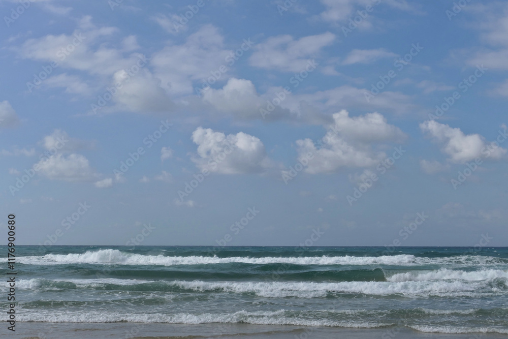 Blue sky with clouds and sea waves on the beach. Beautiful seascape with blue sky and white clouds background. Blue sky with clouds and sea waves on the beach. Beautiful seascape with blue sky and white clouds background.