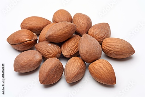 Close up of a group of inshell almonds arranged on a clean white surface, creating an inviting image photo