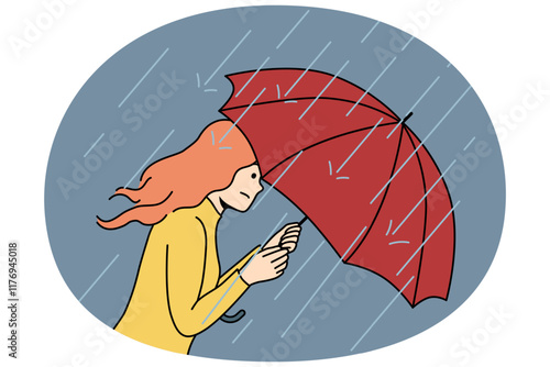 Woman with umbrella rushes home during rain and storm caused by sudden cold snap in autumn and climate change. Girl with umbrella suffers from precipitation and is afraid of getting wet