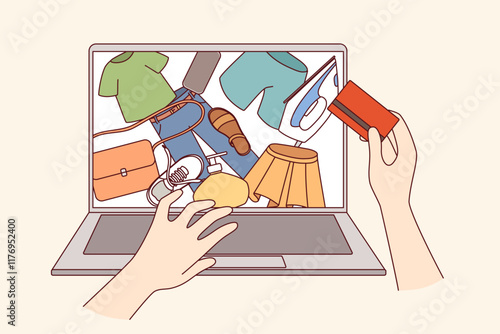 Hands person engaged in online shopping and ordering clothes via internet, thanks to credit card. Shopaholic uses computer for online shopping with delivery to door and saving time on going to store