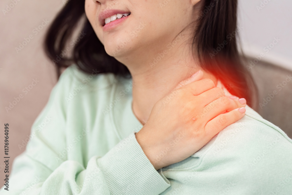 Woman Experiencing Shoulder Pain at Home, Highlighting Discomfort and Need for Medical Attention