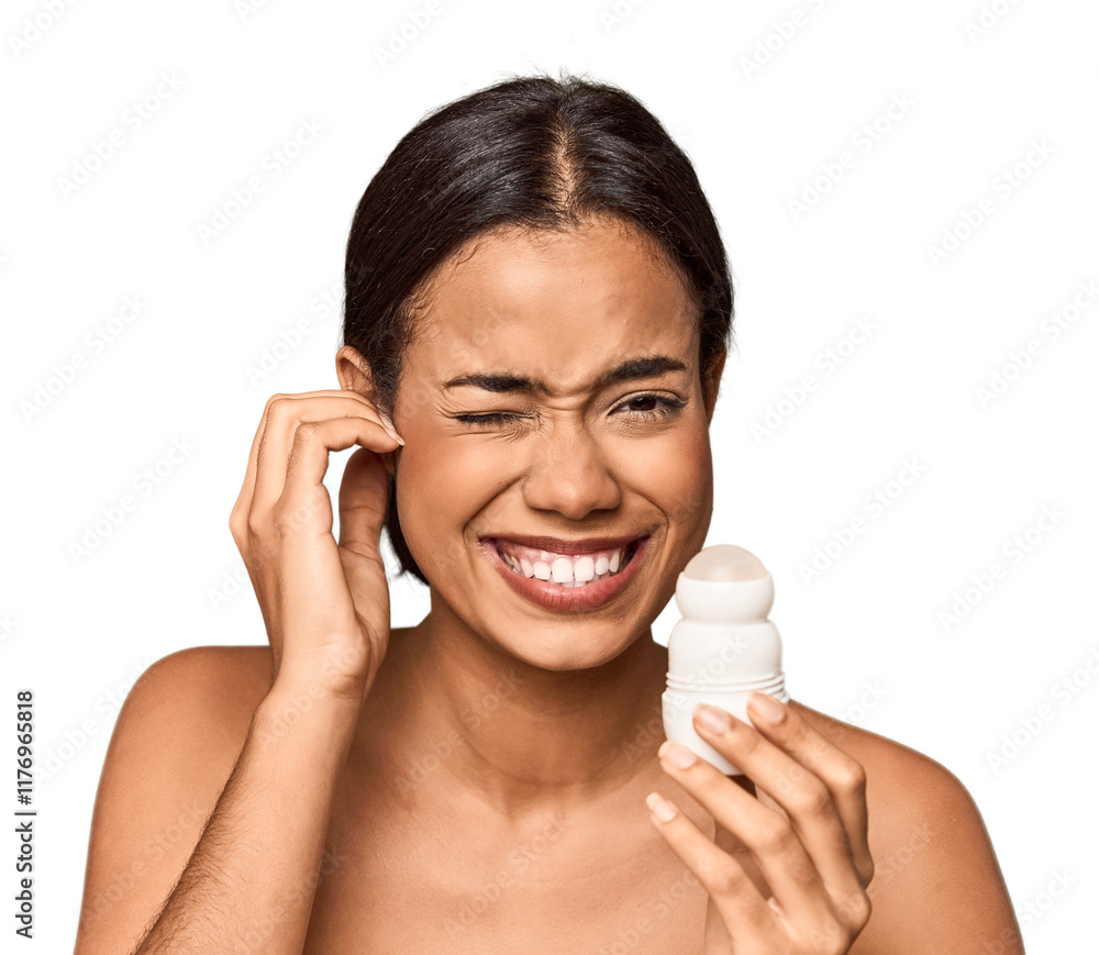 Filipino woman holds deodorant in studio covering ears with hands. Filipino woman holds deodorant in studio covering ears with hands.