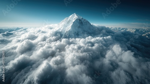 An awe-inspiring view of a mighty mountain peak breaking through a dense cushion of clouds, epitomizing the power and mystery of natural wonders. photo