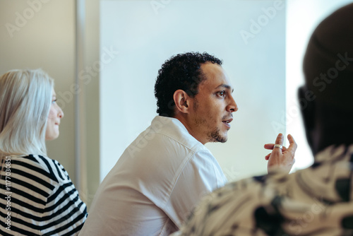 Fényképezés Multiracial businessman engaged in a thoughtful office discussion with colleague