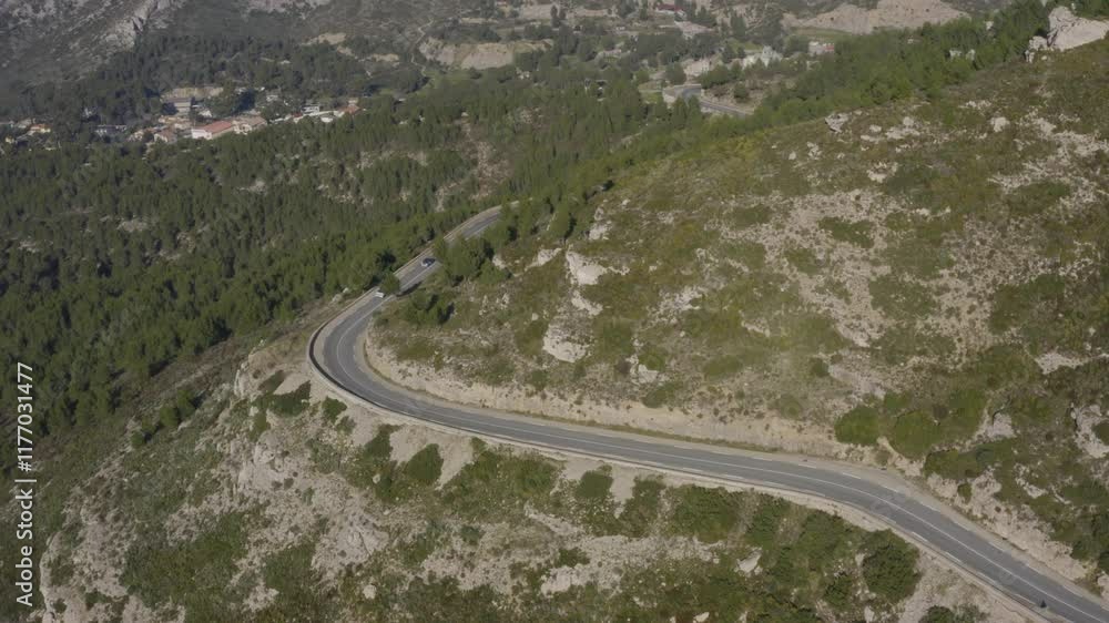 Aerial shot of cars driving on a bucolic road in the Calanques mountains around Marseille, France Aerial shot of cars driving on a bucolic road in the Calanques mountains around Marseille, France